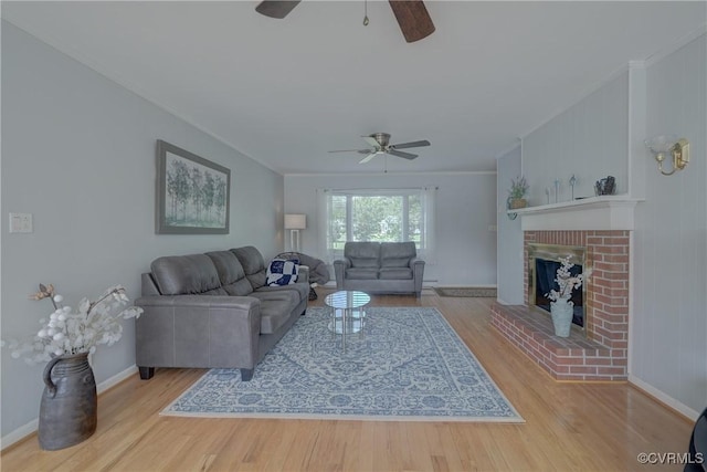 330 Cardinal Ln, White Stone, VA 22578 - living room featuring ceiling fan, wood finished floors, ornamental molding, baseboards, and a brick fireplace