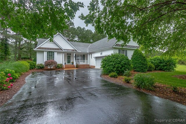 118 Old Field Rd, Irvington, VA 22480 - single story home with asphalt driveway, an attached garage, covered porch, and roof with shingles
