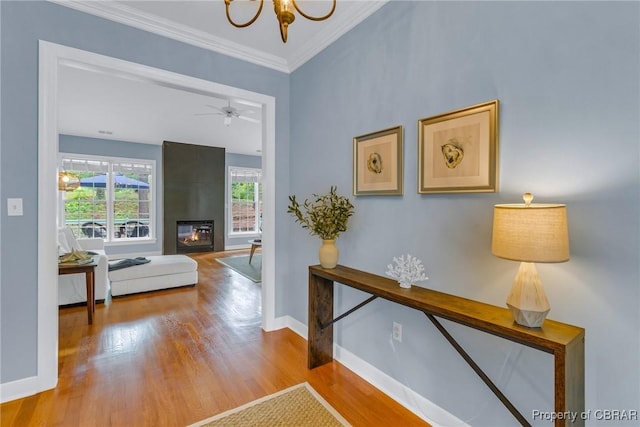 118 Old Field Rd, Irvington, VA 22480 - corridor featuring wood finished floors, baseboards, a chandelier, and crown molding