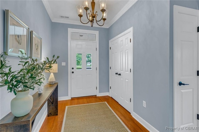 118 Old Field Rd, Irvington, VA 22480 - entryway with a chandelier, wood finished floors, crown molding, and baseboards
