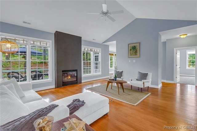118 Old Field Rd, Irvington, VA 22480 - living area featuring wood finished floors, ceiling fan, a large fireplace, baseboards, and high vaulted ceiling