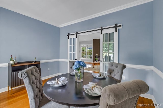 118 Old Field Rd, Irvington, VA 22480 - dining area with a barn door, wood finished floors, ornamental molding, and baseboards