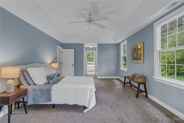 118 Old Field Rd, Irvington, VA 22480 - carpeted bedroom featuring baseboards, a ceiling fan, a raised ceiling, and connected bathroom