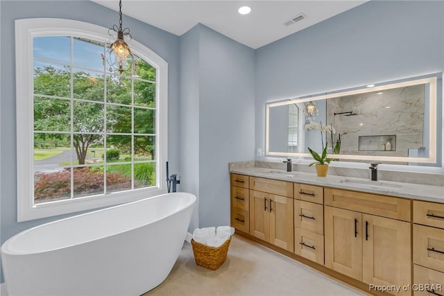 118 Old Field Rd, Irvington, VA 22480 - bathroom with double vanity, a freestanding bath, and a marble finish shower