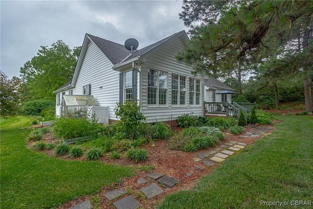 118 Old Field Rd, Irvington, VA 22480 - view of home's exterior featuring a lawn and a wooden deck