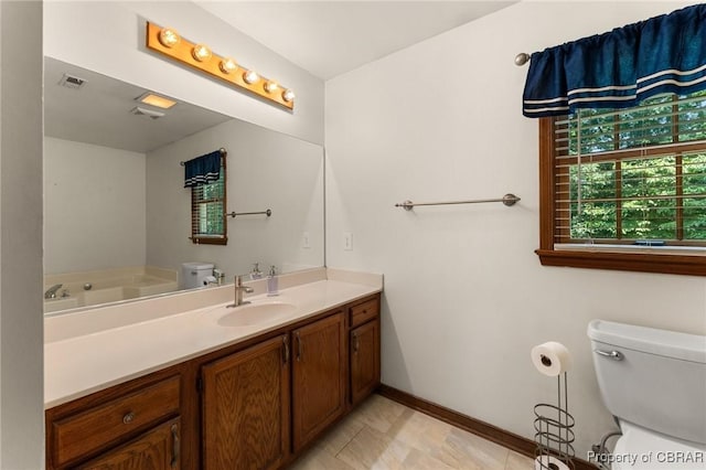 6402 Willow Landing Way, Chester, VA 23831 - bathroom with toilet, vanity, baseboards, and a garden tub