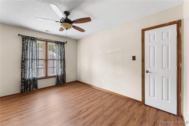 6402 Willow Landing Way, Chester, VA 23831 - unfurnished room featuring wood finished floors, a ceiling fan, and a textured ceiling