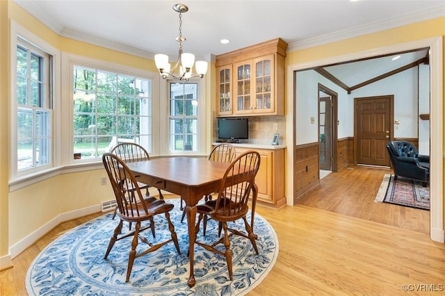 1813 Locust Hill Rd, Henrico, VA 23238 - dining area featuring healthy amount of natural light, ornamental molding, a chandelier, light wood-style floors, and wainscoting