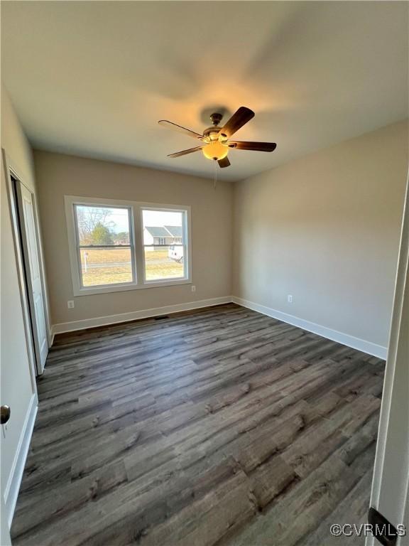 27 Otter Ln, Montross, VA 22520 - spare room featuring dark wood-type flooring, baseboards, and a ceiling fan