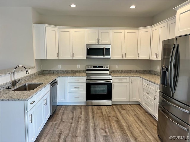 27 Otter Ln, Montross, VA 22520 - kitchen featuring stainless steel appliances, a sink, white cabinetry, recessed lighting, and light wood finished floors