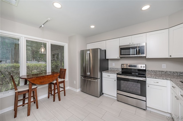 2750 Old Point Dr, Henrico, VA 23233 - kitchen featuring appliances with stainless steel finishes, white cabinetry, light stone countertops, hanging light fixtures, and recessed lighting