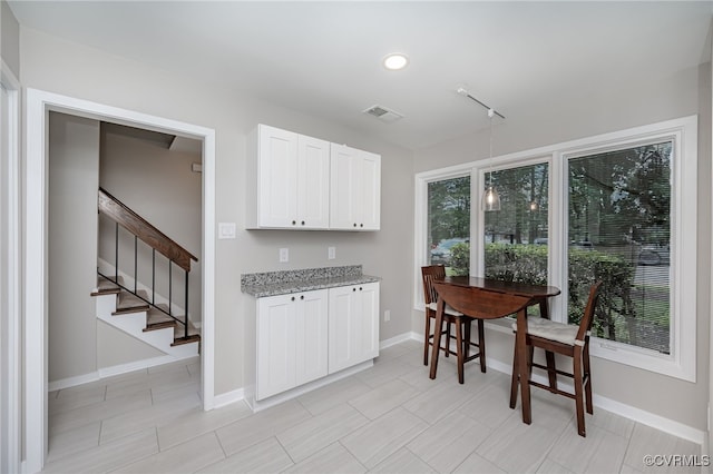 2750 Old Point Dr, Henrico, VA 23233 - kitchen featuring light stone countertops and white cabinetry