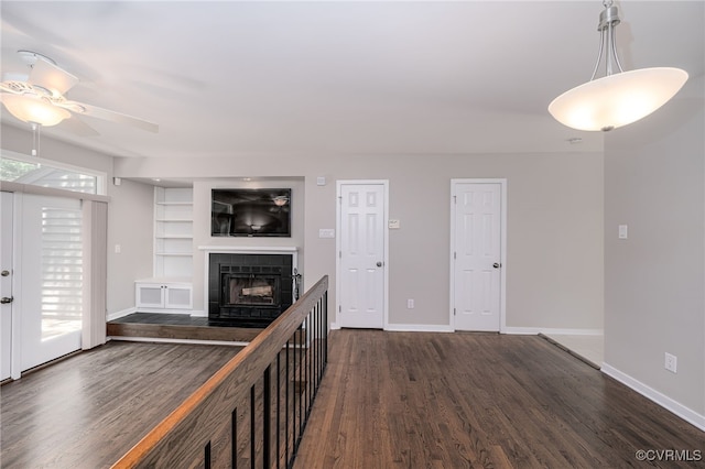 2750 Old Point Dr, Henrico, VA 23233 - unfurnished living room featuring dark wood-style flooring, a ceiling fan, a fireplace, and built in features