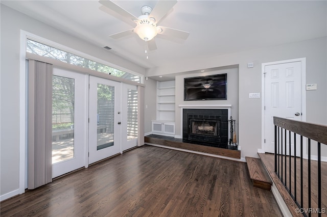 2750 Old Point Dr, Henrico, VA 23233 - unfurnished living room featuring wood finished floors, ceiling fan, a fireplace with raised hearth, and built in features