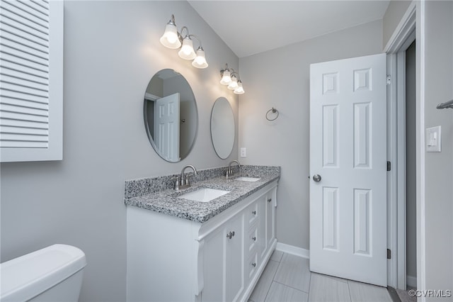 2750 Old Point Dr, Henrico, VA 23233 - full bathroom with double vanity, toilet, and baseboards