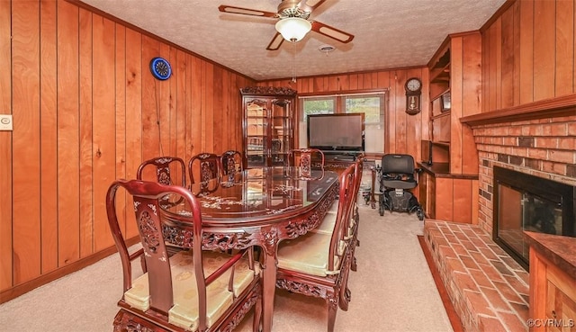 2931 Delfin Rd, Midlothian, VA 23112 - carpeted dining room with wooden walls, a ceiling fan, ornamental molding, a textured ceiling, and a fireplace