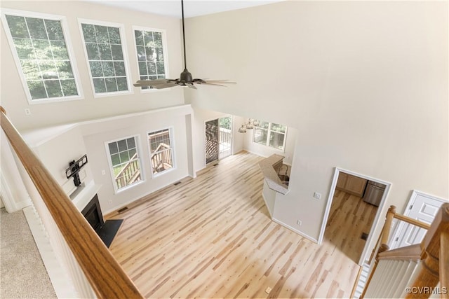 11830 Cedar Landing Ter, Chesterfield, VA 23831 - unfurnished living room featuring a high ceiling, a fireplace with flush hearth, healthy amount of natural light, wood finished floors, and ceiling fan