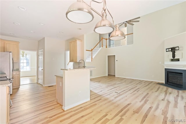 11830 Cedar Landing Ter, Chesterfield, VA 23831 - kitchen with light wood finished floors, light brown cabinetry, freestanding refrigerator, open floor plan, and recessed lighting