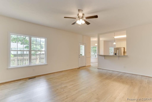 106 Haymaker Pl, Williamsburg, VA 23185 - unfurnished living room featuring ceiling fan, light wood-style flooring, and baseboards