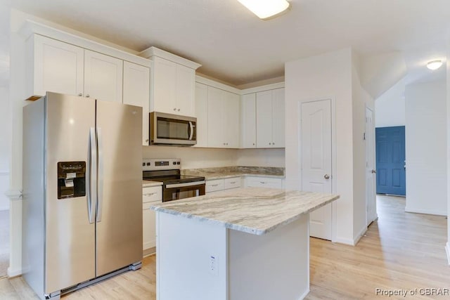 106 Haymaker Pl, Williamsburg, VA 23185 - kitchen with appliances with stainless steel finishes, light wood finished floors, white cabinets, light stone countertops, and a kitchen island