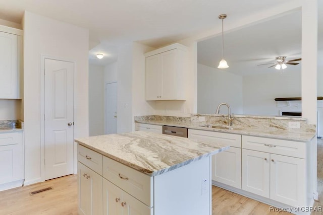 106 Haymaker Pl, Williamsburg, VA 23185 - kitchen featuring light wood-style flooring, a sink, white cabinets, and a ceiling fan