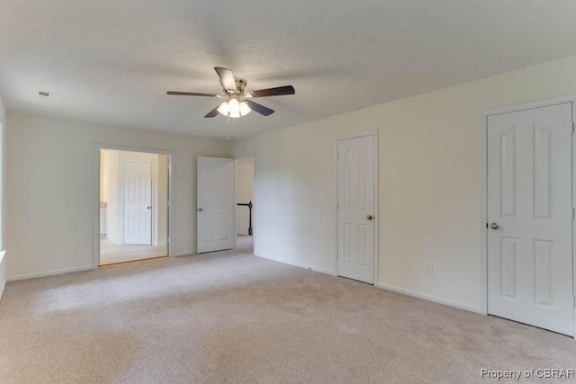 106 Haymaker Pl, Williamsburg, VA 23185 - unfurnished bedroom with light carpet, baseboards, and a ceiling fan