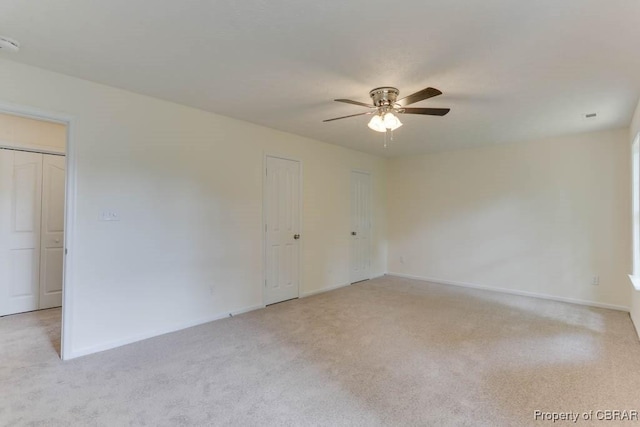 106 Haymaker Pl, Williamsburg, VA 23185 - unfurnished bedroom with light colored carpet, baseboards, a ceiling fan, and two closets