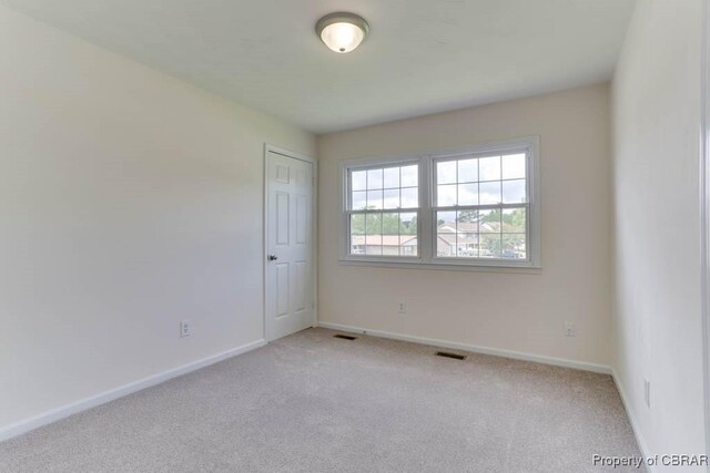 205 Captains Ct, Hampton, VA 23669 - spare room featuring light colored carpet and baseboards