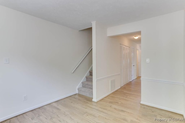 1603 Skiffes Creek Cir, Williamsburg, VA 23185 - empty room with wood finished floors, stairway, and baseboards