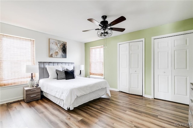 12321 Boxford Ln, Chesterfield, VA 23114 - bedroom featuring multiple closets, wood finished floors, baseboards, and a ceiling fan