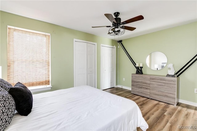12321 Boxford Ln, Chesterfield, VA 23114 - bedroom with wood finished floors, baseboards, multiple closets, and a ceiling fan