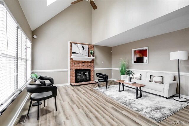 12321 Boxford Ln, Chesterfield, VA 23114 - living room with high vaulted ceiling, wood finished floors, ceiling fan, a brick fireplace, and baseboards