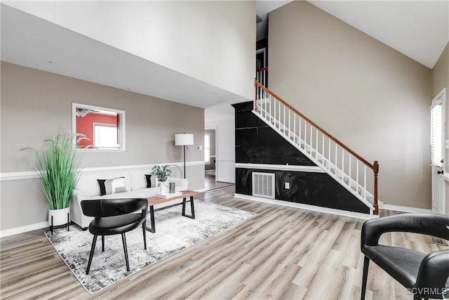 12321 Boxford Ln, Chesterfield, VA 23114 - living area featuring stairway, wood finished floors, high vaulted ceiling, and baseboards