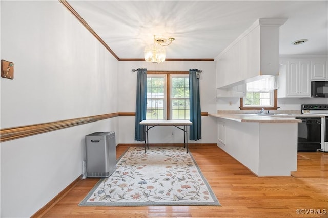 7708 Walnut Cir, Quinton, VA 23141 - kitchen featuring black appliances, white cabinets, a chandelier, light countertops, and a peninsula