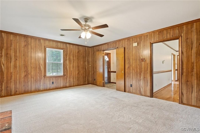 7708 Walnut Cir, Quinton, VA 23141 - unfurnished bedroom featuring wooden walls, baseboards, carpet flooring, crown molding, and a ceiling fan