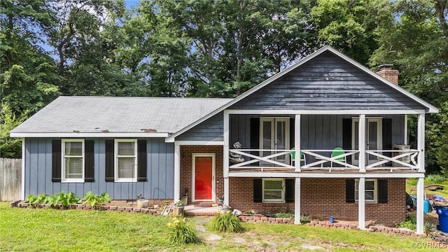 9540 Alfaree Rd, Chesterfield, VA 23237 - view of front of property featuring a balcony, a chimney, a front lawn, and board and batten siding