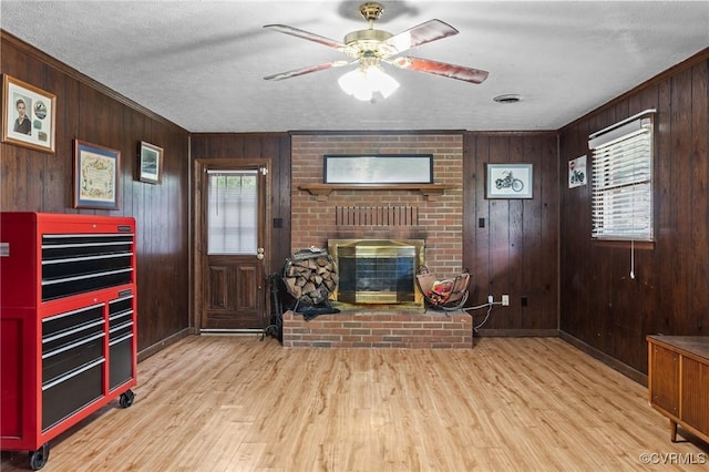 9540 Alfaree Rd, Chesterfield, VA 23237 - living room with a fireplace, wood walls, wood finished floors, ornamental molding, and a ceiling fan
