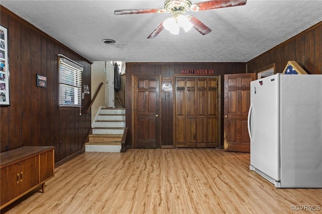 9540 Alfaree Rd, Chesterfield, VA 23237 - interior space featuring wooden walls, light wood-type flooring, a textured ceiling, ceiling fan, and stairway