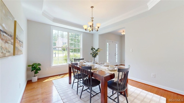 11706 Black Alder Dr, Moseley, VA 23120 - dining space featuring ornamental molding, a chandelier, a raised ceiling, light wood-style flooring, and baseboards