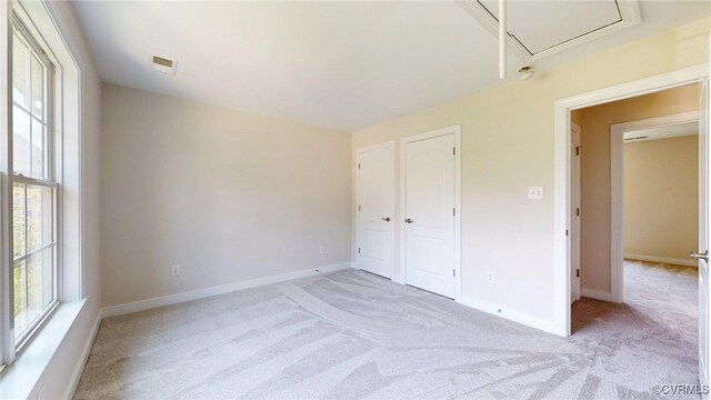 11706 Black Alder Dr, Moseley, VA 23120 - unfurnished bedroom featuring light colored carpet, attic access, baseboards, and a closet