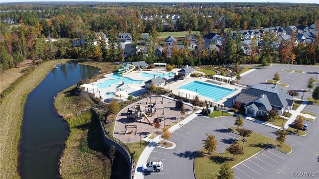 11706 Black Alder Dr, Moseley, VA 23120 - aerial view of property and surrounding area featuring a pool, a nearby body of water, and a heavily wooded area