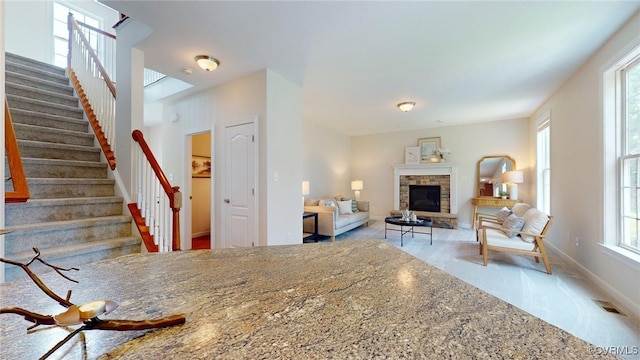 11706 Black Alder Dr, Moseley, VA 23120 - living area with stairs, a fireplace, carpet floors, and baseboards