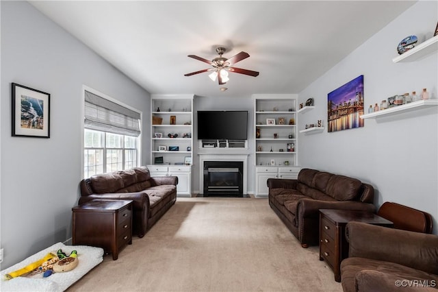 8940 Kings Charter Dr, Hanover, VA 23116 - living room featuring ceiling fan, light carpet, and a fireplace with flush hearth