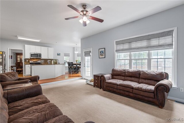 8940 Kings Charter Dr, Hanover, VA 23116 - living area featuring light colored carpet and a ceiling fan