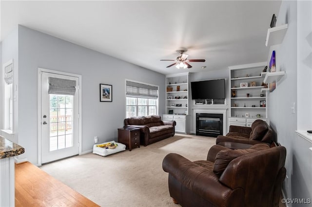 8940 Kings Charter Dr, Hanover, VA 23116 - living room featuring ceiling fan, a fireplace with flush hearth, and carpet floors