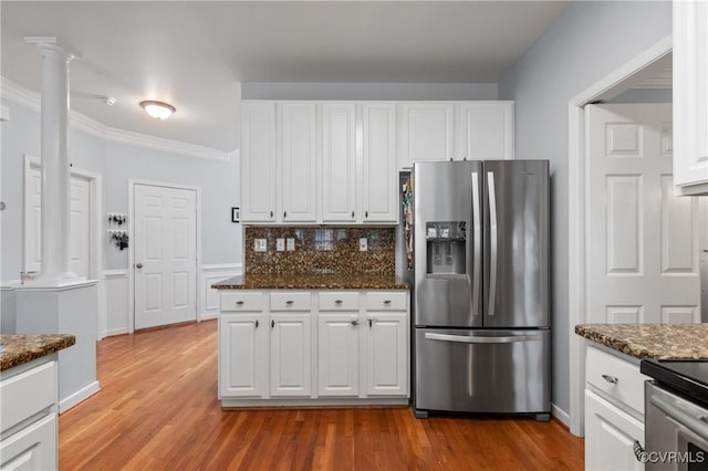 8940 Kings Charter Dr, Hanover, VA 23116 - kitchen with stainless steel refrigerator with ice dispenser, white cabinetry, dark stone counters, and crown molding