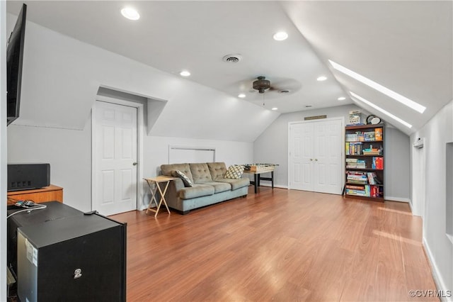 8940 Kings Charter Dr, Hanover, VA 23116 - living room with vaulted ceiling, light wood-style flooring, recessed lighting, a ceiling fan, and a skylight