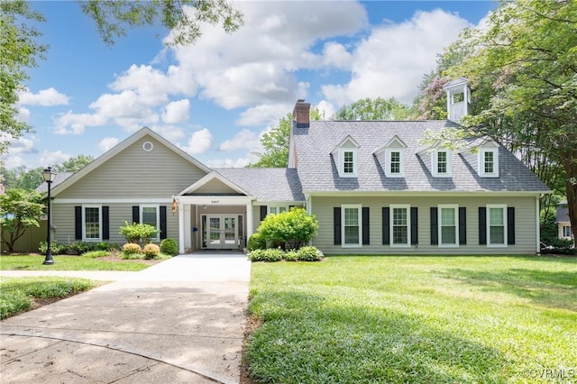 8940 Kings Charter Dr, Hanover, VA 23116 - view of front facade featuring french doors, concrete driveway, and a front lawn