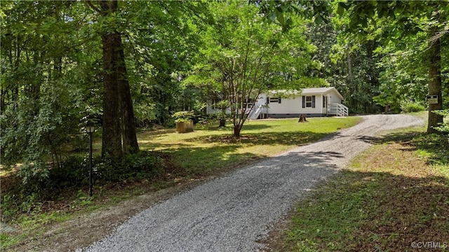 10780 Winchester Dr, Amelia Courthouse, VA 23002 - view of property hidden behind natural elements with gravel driveway, crawl space, and a forest view