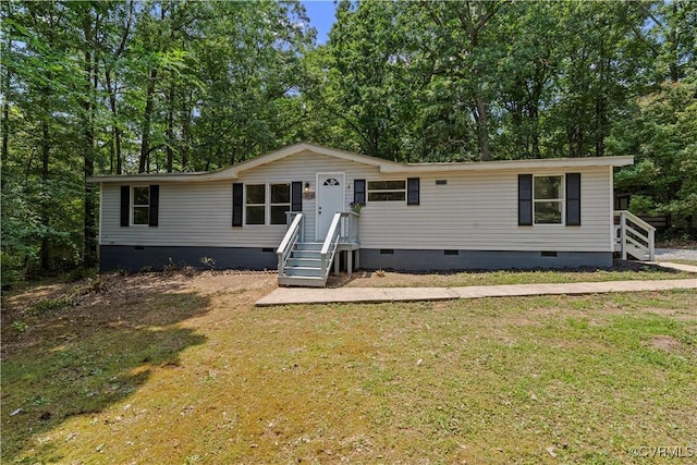 10780 Winchester Dr, Amelia Courthouse, VA 23002 - manufactured / mobile home with crawl space, a front lawn, and view of scattered trees